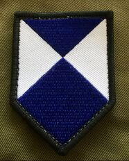 Embroidered patch of the blue and white shield on a piece of green fabric