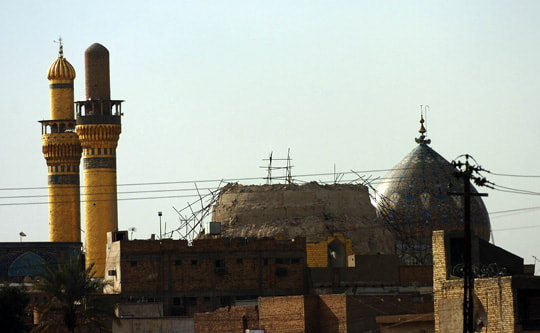 Mosque with a dome that has fallen in and two minarets
